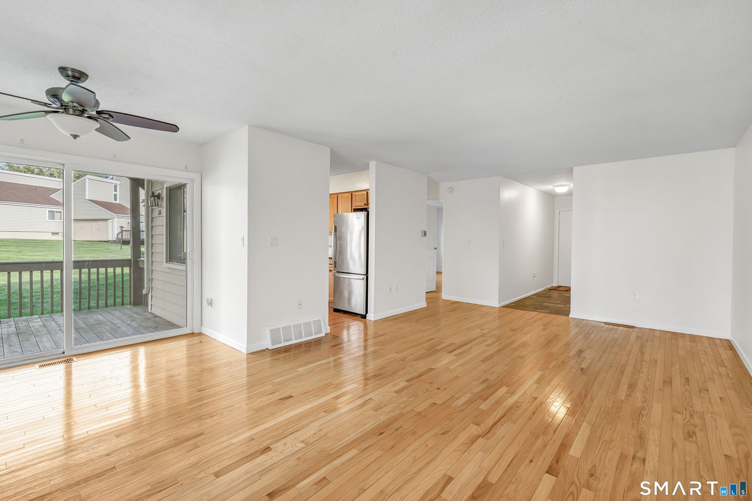 Living area with hardwood floors and covered deck at 16 Monticello Drive, Unit 16